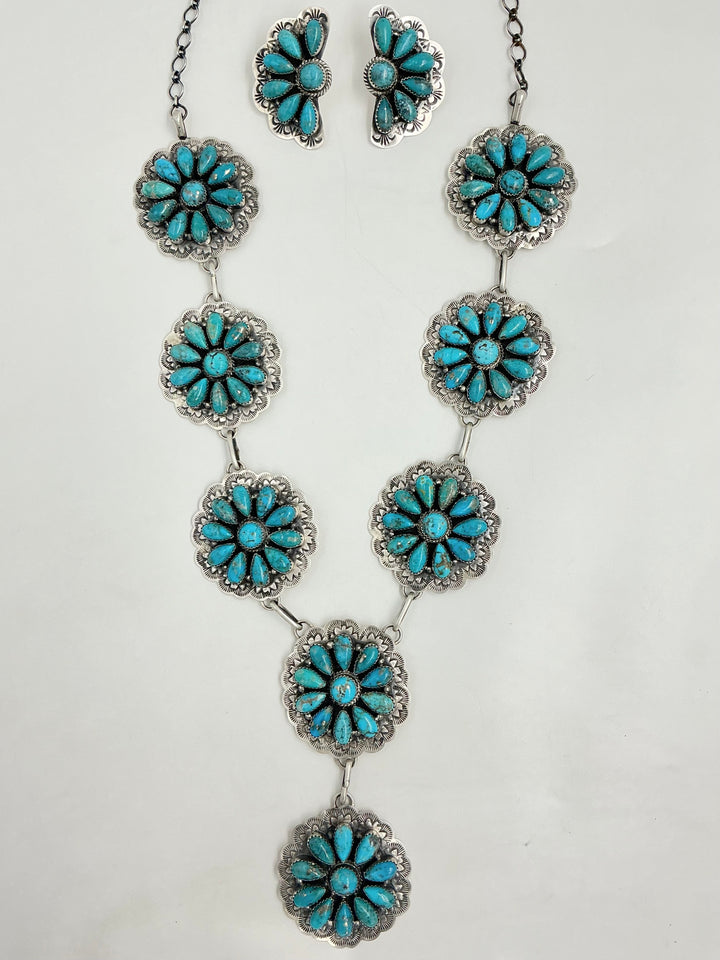 Y Shaped necklace and earrings set with turquoise floral designs on a white background