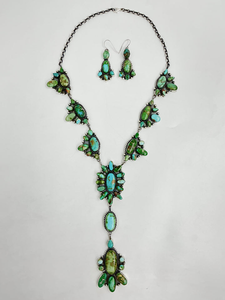 Y shaped necklace and earrings set with green and turquoise stone clusters set on sterling silver on a white background