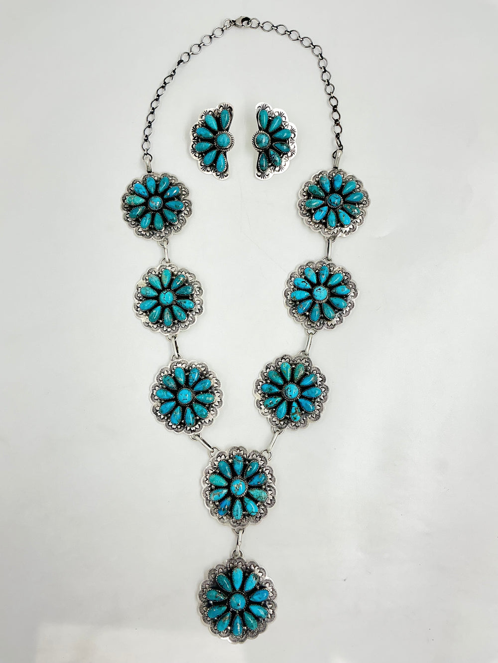 Y shaped Turquoise floral necklace and earrings on a white background