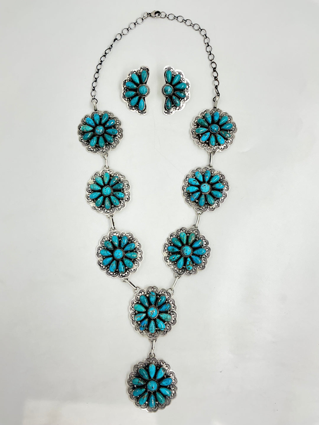 Y shaped Turquoise floral necklace and earrings on a white background