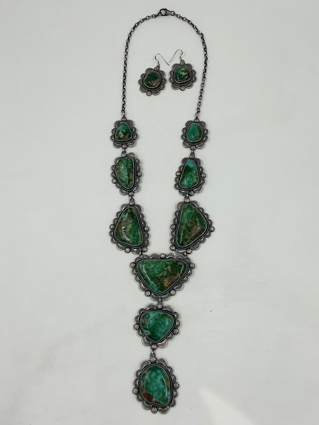 Y shaped Necklace with green gemstones and set in sterling silver with accents on a white background