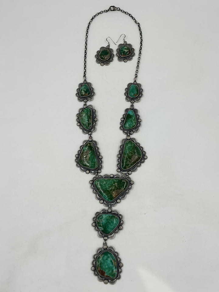 Y shaped Necklace with green gemstones and set in sterling silver with accents on a white background