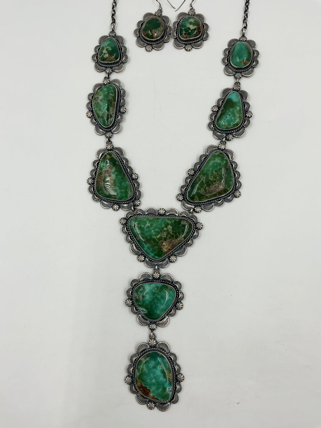 Y shaped Necklace with green gemstones and set in sterling silver with accents on a white background