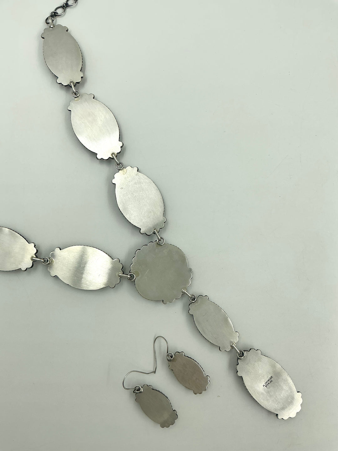Silver back of Y shaped necklace with  sterling silver on a white background
