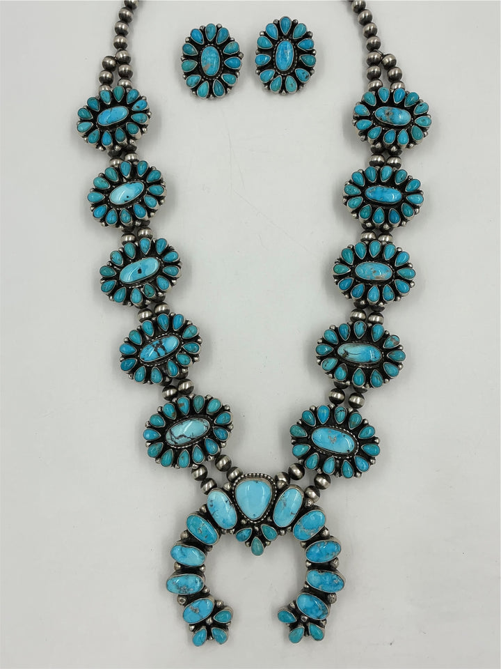 Turquoise stone necklace and earrings on a white background